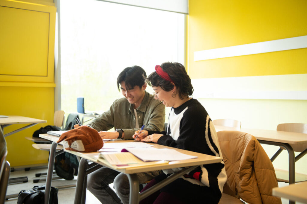 twee leerlingen in de klas lachen